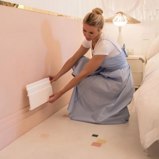 Designer holding a sample piece of skirting board